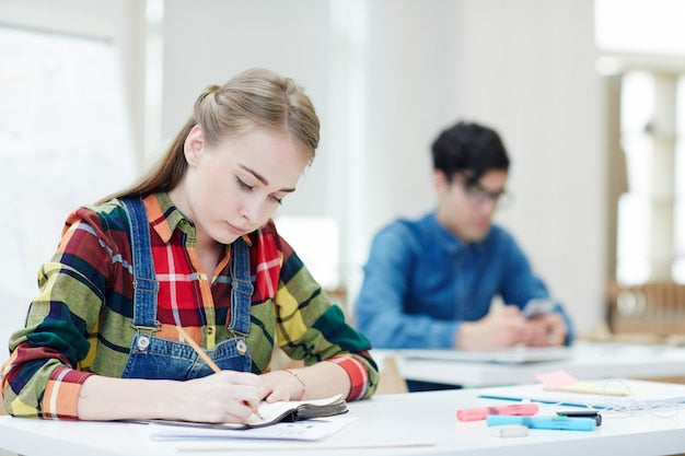 Sala de examen tipo test con opositores realizando una prueba, contexto de las normas del examen del TAI