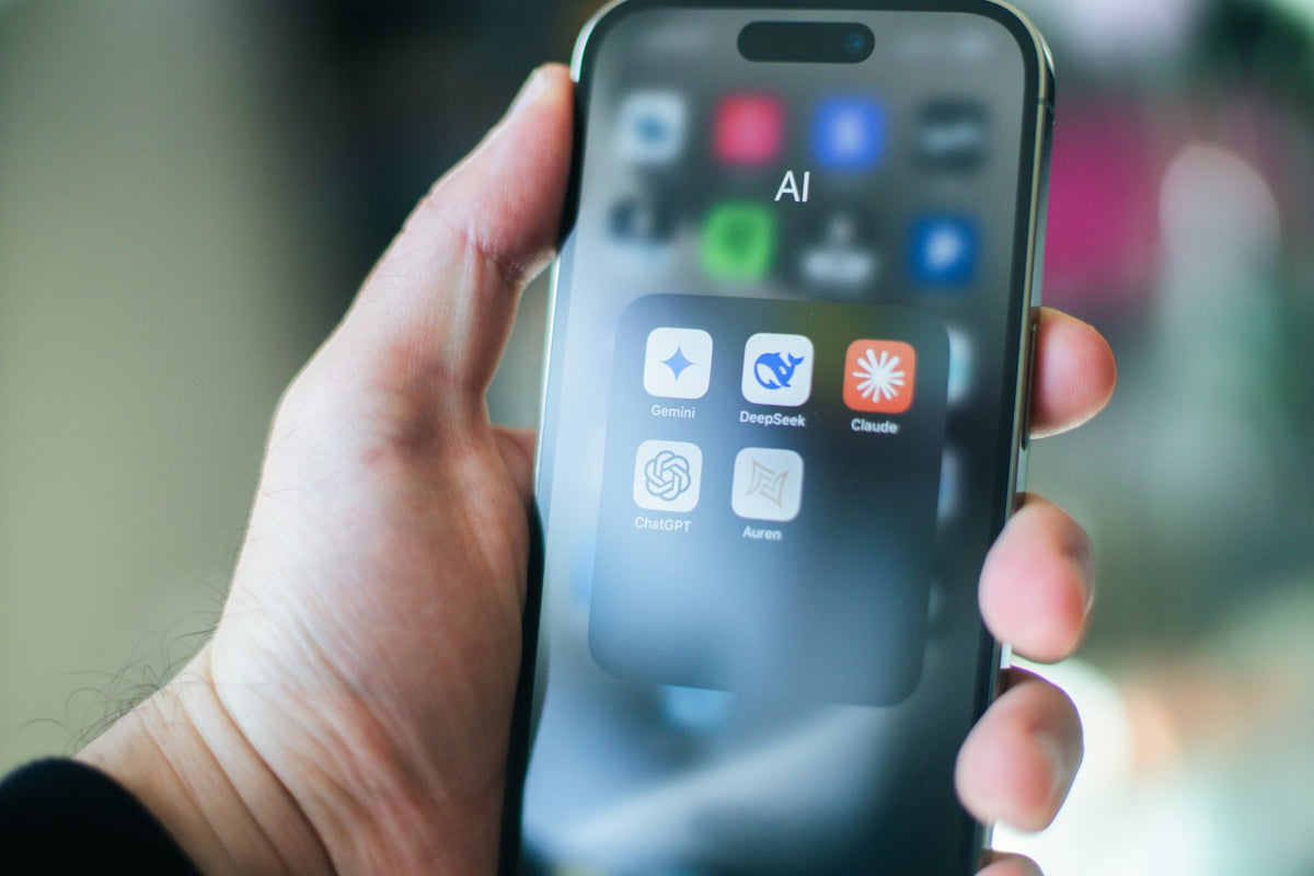 Mano sosteniendo un smartphone con varias aplicaciones abiertas